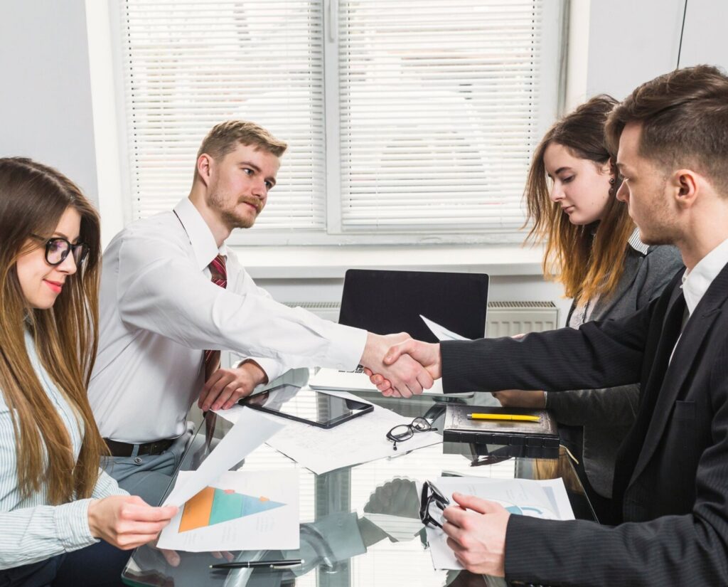 People shake hands in office